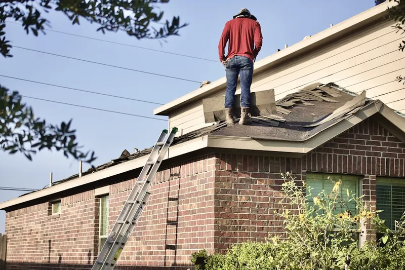 Professional roofer working on a residential roof in Lower Boston Street